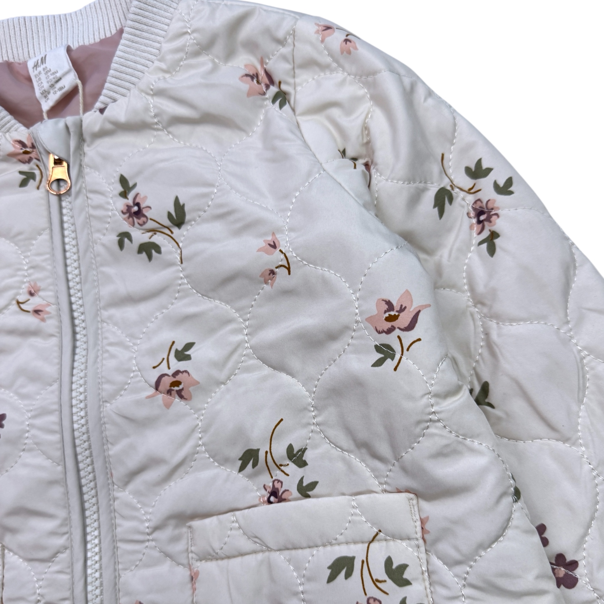 Krémový prošívaný bomber s motivem květin H&M
